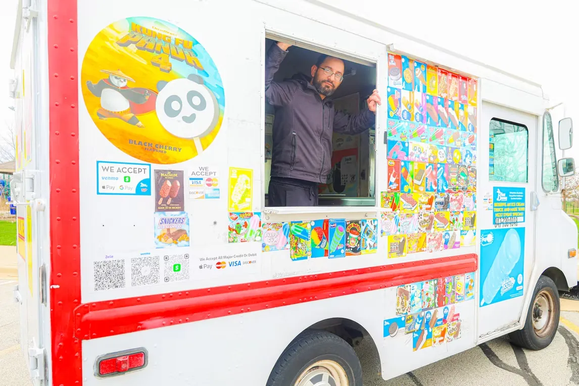 Close view of the truck showing the full menu wall, the payment decals and the booking number.